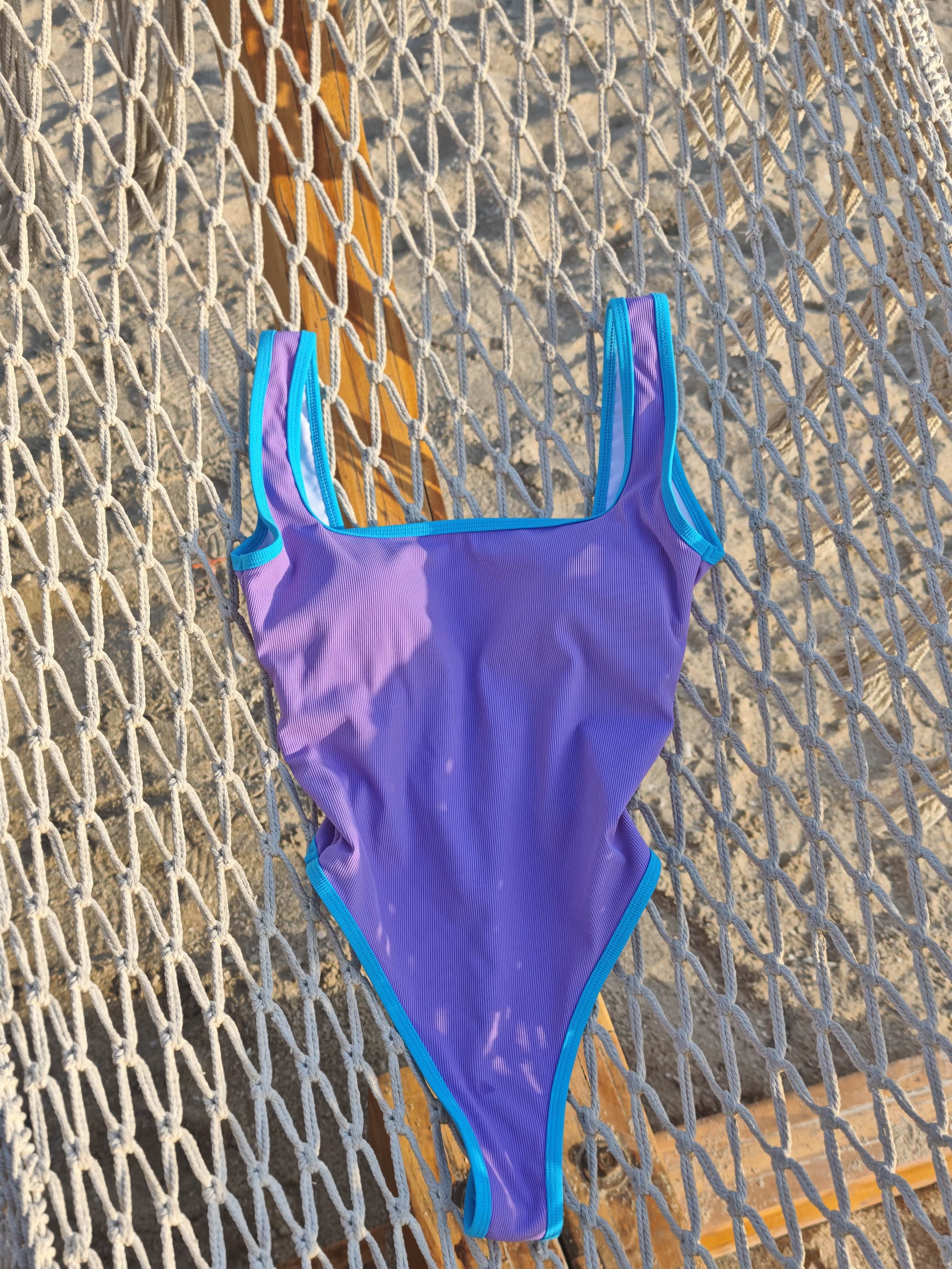 Close-up of Patisserie Mix swimsuit fabric – smooth stretch material with pink, mint, and lavender panels

