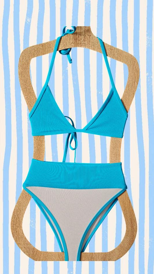 Blue bikini set on a wooden hanger against a striped background